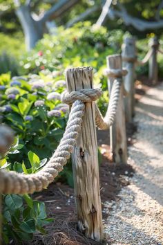 rope wrapped around wooden posts in a garden