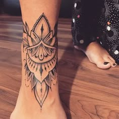 a woman's foot with a tattoo on it