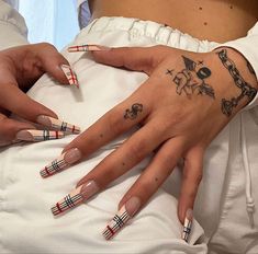 two people with matching tattoos on their hands