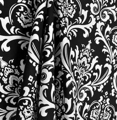 black and white wallpaper with an ornate design on it's side, as well as the bottom half