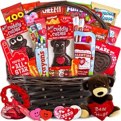 a valentine's day gift basket filled with chocolates, candy and candies