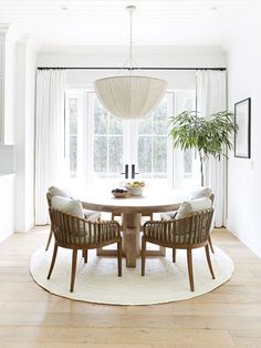 a dining room table with four chairs around it