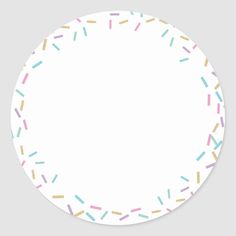 a white plate with colorful sprinkles on the side and a circle in the middle