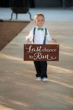 a little boy holding a sign that says last chance to run