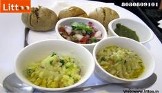 there are four bowls with different foods in them on the plate, and one bowl is filled with vegetables