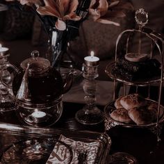 an assortment of pastries and teapots on a table