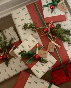 presents wrapped in red and white paper with christmas decorations on them