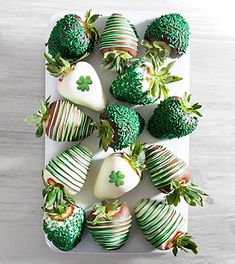 chocolate covered strawberries are arranged in the shape of shamrocks and strawberrys with green leaves on them