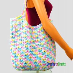 a crocheted handbag is displayed on a mannequin's head