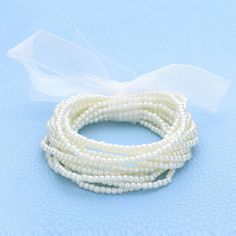 Size : 1.6" H Stretchable Adjustable White Stretch Bracelet For Party, Adjustable Beaded Stretch Bracelet In Pearl White, Adjustable Pearl White Beaded Stretch Bracelet, Adjustable Beaded Bracelets For Spring Party, White Bracelets For Summer Party, Spring Beaded White Pearl Bracelet, Summer Party Beaded Bracelets, White Summer Party Bracelets, Adjustable Pearl Beads For Party