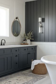 a bathroom with dark gray cabinets and white fixtures