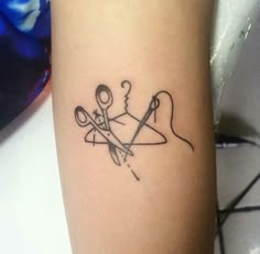 a tattoo on the arm of a woman with scissors