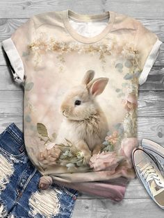 a t - shirt with an image of a rabbit on it and some ripped jeans