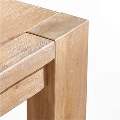 a close up view of a wooden table with one drawer open and the other closed