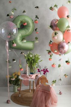 the balloons are in the air and there is a small table with flowers on it