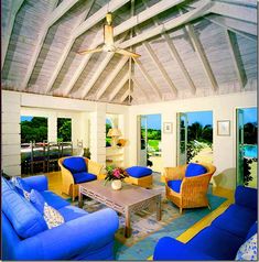 a living room filled with blue couches and chairs