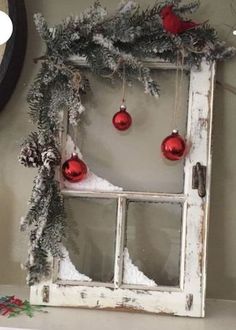 an old window decorated for christmas with ornaments