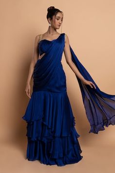 Blue pre-draped tiered ruffled saree in satin georgette base. Paired with a pleated padded blouse with embellished straps. - Aza Fashions Draped Saree Gown, Ruffled Saree, Ruffle Sarees, Lehenga Saree Design, Ruffle Saree, Saree Gown, Padded Blouse, Drape Saree, Draped Blouse