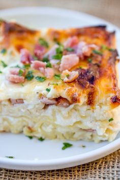 a close up of a plate of food with ham and cheese casserole on it