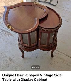 two wooden tables with glass doors on each side and the words unique heart shaped vintage side table