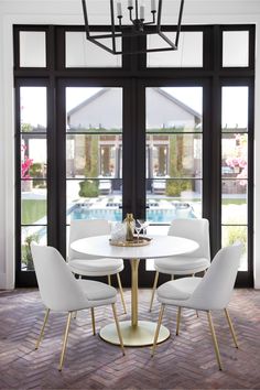 a dining room table with four chairs around it