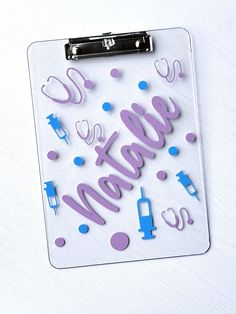 a clipboard with the words welcome written in purple and blue on it, surrounded by confetti