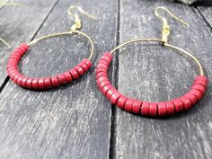 These boho beaded hoop earrings are entirely handmade! I started by wrapping gold-colored 20 gauge German wire in the shape of a circle, then added the 25 4mm x 2mm red howlite (imitation turquoise) heishi beads by hand and wrapped the wire around itself to form and secure a loop. After that, I added a gold-plated surgical steel ear wire, making these earrings safe for the most sensitive of ears. Howlite is predominantly a calming stone. It is said to calm the overactive mind and relieve stress. Red Bead Earrings, Howlite Jewelry, Hoop Earrings Handmade, Handmade Hoop Earrings, Gemstone Hoop Earrings, Calming Stones, Red Jewelry, Red Gemstones, Earrings Red