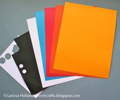 four different colors of paper laid out on top of each other