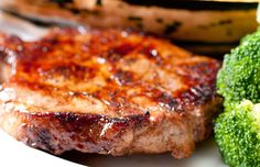 some meat and broccoli on a plate with the words country style baked pork chops recipe