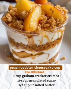 a dessert dish with peach cobbler cheesecake cup and graham cracker crumbs