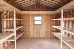 the inside of a storage room with wooden shelves