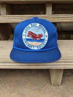 Vintage 80's 90's Long Bay Model Aircraft Society Snapback Rope Hat. Has normal vintage wear. Has crease behind patch. NO holes. In good vintage condition... Ready To Wear!! One Size Fits Most. Vintage Adjustable Snapback Hat With Curved Brim, Vintage Snapback Hat With Curved Brim And Logo Patch, Vintage Blue Snapback Hat With Flat Bill, Vintage Adjustable Snapback Cap, Vintage Blue Trucker Hat, Vintage Adjustable Baseball Cap With Flat Brim, Vintage Blue Snapback Hat, Vintage Adjustable Flat Brim Baseball Cap, Vintage Adjustable Flat Bill Hat