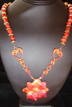 This is truly a one of a kind piece. I love the work of Patricia Healy who does all the great fired copper. So I had the flower and then created the necklace to go with it. The flower is on a chain link that will allow you to switch out the pendant if you so choose. That is also by Patricia Healey. So I paired the pendant and holder with other copper and beautiful Red Jasper. Wow, what a stunning necklace. The necklace itself is 27 Inches long. The clasp is a copper hook and eye clasp. The match Red Copper Pendant Necklace, Unique Copper Flower Jewelry, Unique Hand Forged Red Jewelry, Handmade Red Copper Jewelry, Handmade Red Copper Necklace, Unique Red Copper Necklace, Artisan Hand Forged Red Jewelry, Artisan Rust-colored Jewelry For Gifts, Unique Handmade Rust-colored Jewelry