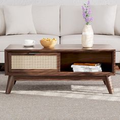 a coffee table sitting on top of a carpeted floor next to a white couch