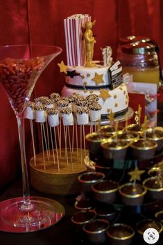 a table topped with lots of cakes and desserts