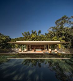 an outdoor swimming pool with lounge chairs and trees in the backgroung area