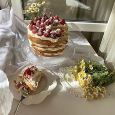 there is a cake with strawberries on the top and other desserts next to it