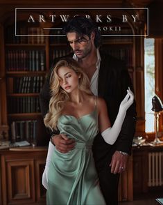 a man and woman standing next to each other in front of a book shelf with bookshelves