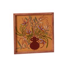 a painting with flowers and leaves in a wooden frame