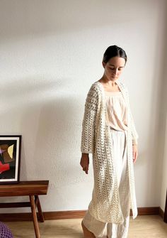 This long cardigan, has a gorgeous crochet stitch 100% handmade. This cotton kimono cardigan has a beautifull open closure. This beige crochet cover up is made with hight quality cotton yarn, anti allergic and super super soft. This amazing maxi cardigan is the gargment that you would want wear it forever! Perfect to wear it with dresses or with a jean! Super comfortable, stylish and versatile! WHICH IS MY SIZE? This long cardigan is available in different sizes.  In order to know which is the perfect size for you, you just have to measure your chest . Below, you can find the measurements referred to every size: Measurements referring to the chest contour:  Size S: 80 cm / 32 in. Size M: 90 cm / 35 in. Size L: 100 cm / 39 in. If you can't find your size or you are not sure about the size, White Oversized Cardigan For The Beach, Oversized White Cardigan For Beach, Handmade Bohemian Spring Cardigan, One Size Bohemian Crochet Cardigan, One Size Cozy Cardigan For The Beach, Cozy One Size Cardigan For The Beach, Cozy One-size Cardigan For The Beach, Bohemian Crochet Cardigan One Size, White Bohemian Long Outerwear