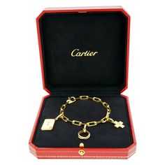 Circa 2000s, 18k, by Cartier, France. Timeless and tailored, this Cartier charm bracelet is the perfect everyday gold bracelet. Dressed for cocktails or effortlessly casual, it lays comfortably on the wrist. Festooned with a miniature trinity ring, a diamond-set cross or plus sign, and a love letter complete with a place to write a message in marker or engrave a permanent sentiment, it is perfect as is or add more Cartier charms to suit. Exquisitely made with the distinctive quality that Cartier Everyday Gold Bracelet, Plus Sign, Trinity Ring, Monogram Bracelet, Modern Bracelets, Cartier Bracelet, Gold Armband, A Love Letter, Diamond Set