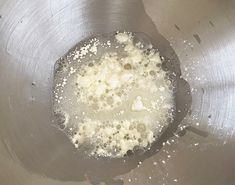 a metal bowl filled with liquid and white stuff