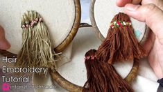 someone is working on some kind of crafting project with yarn and wood hoops