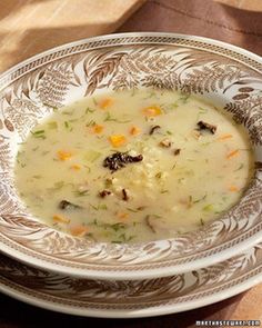 a bowl filled with soup sitting on top of a wooden table