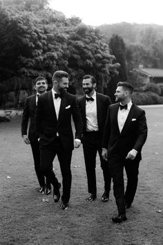 three men in tuxedos are walking together