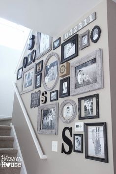 a staircase with many pictures on the wall