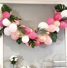 the table is decorated with balloons and palm leaves