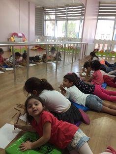 children sitting on the floor in a classroom