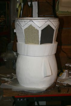 a large white vase sitting on top of a table