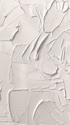 white paint is being applied on the wall in an artistic manner with various shapes and sizes